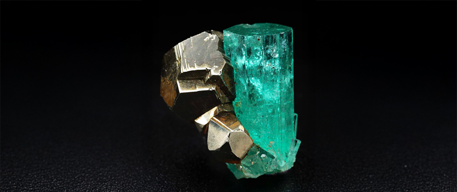 hexagonal emerald crystal with dodecahedral pyrite crystals from the Chivor mine